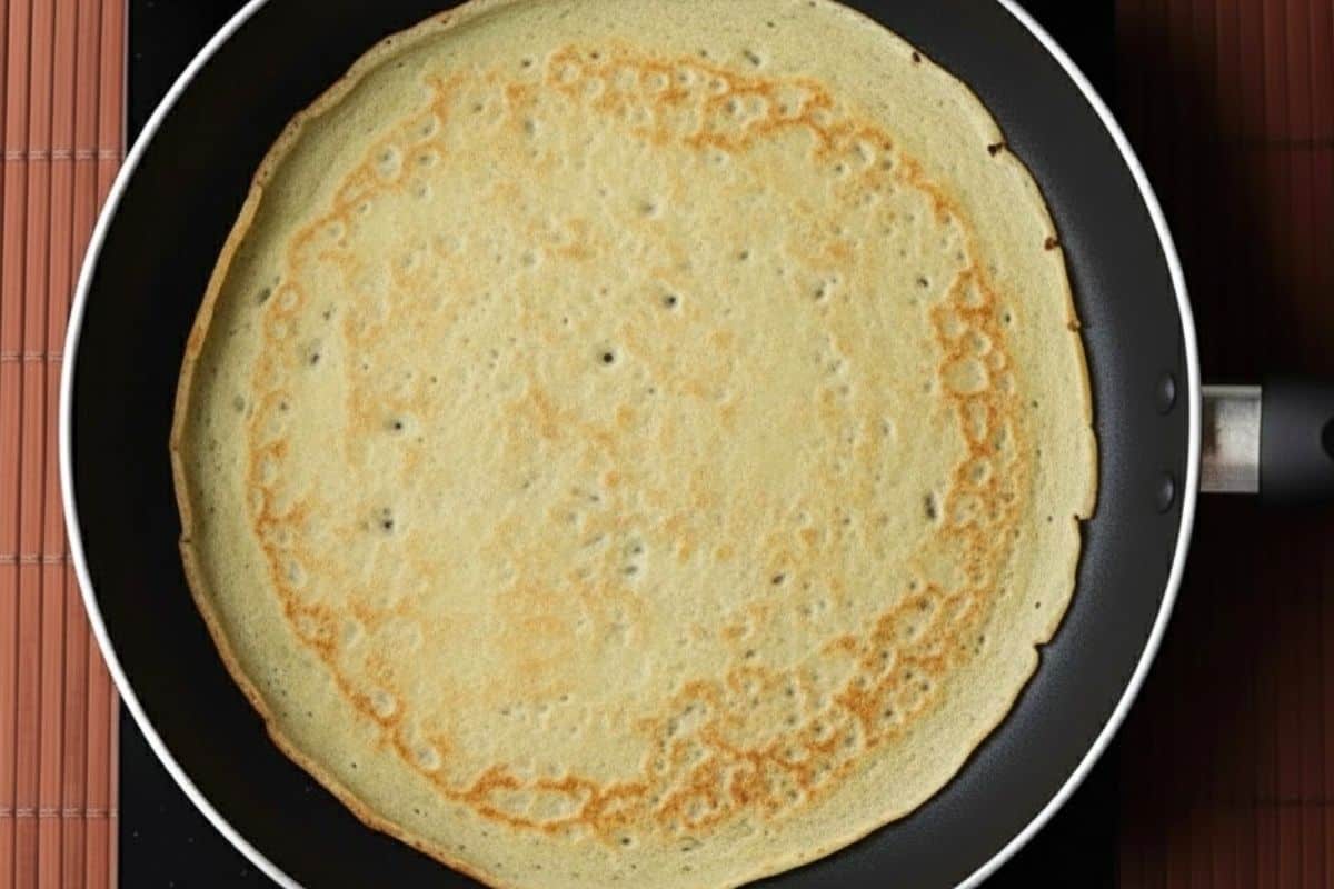 Once edges turn golden, flip the crepe using your fingers or a spatula. - 6