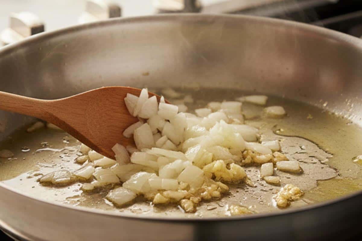 Sautéing the onion and garlic in a pan. - 4