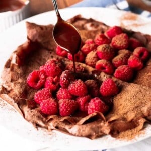 Raspberry sauce being drizzled over Chocolate Covered Raspberry Crepes