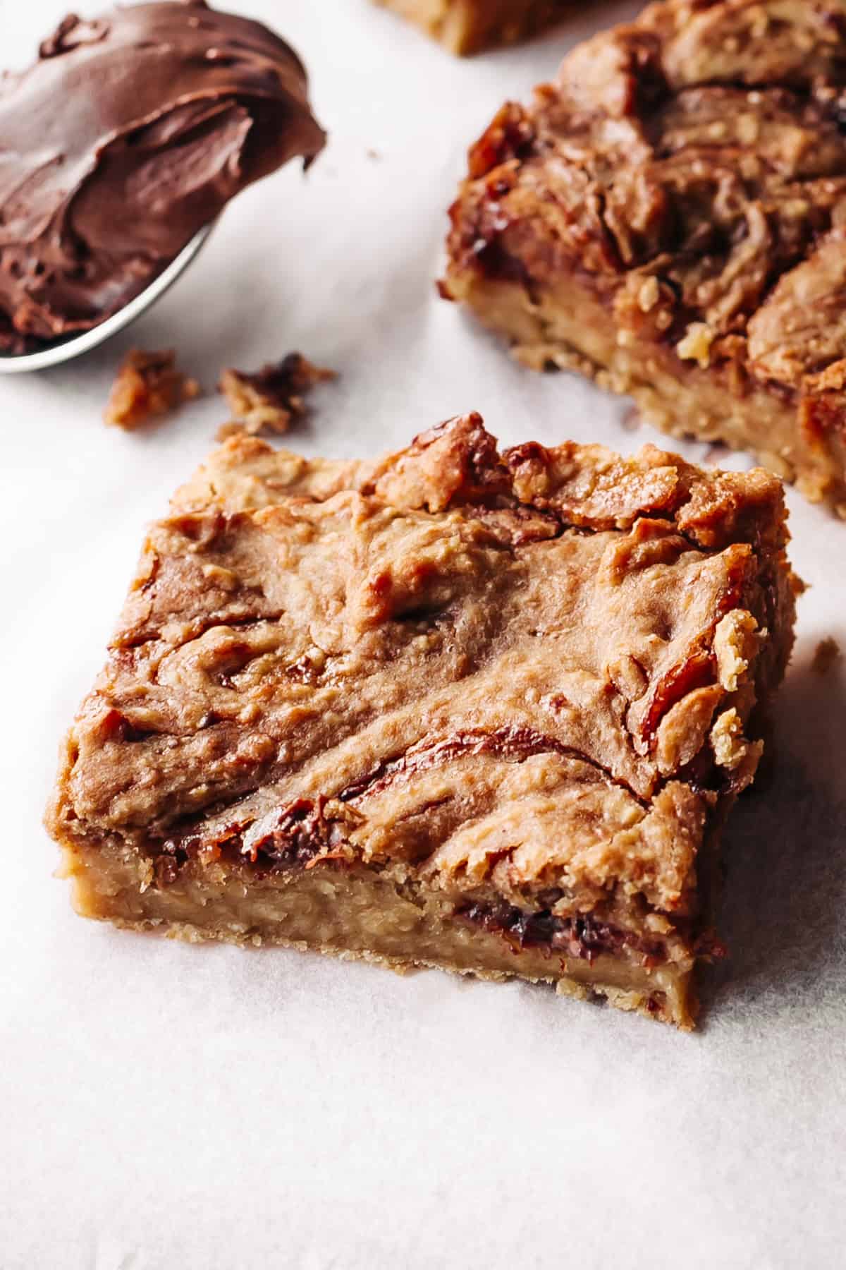 Jam and Nutella swirled blondies on parchment paper