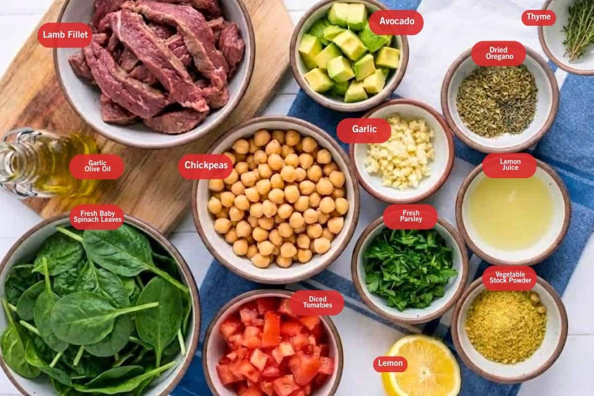 Flat lay photo of ingredient shot of lamb fillet, avocado, thyme, dried oregano garlic, garlic olive oil, diced tomatoes. lemon, vegetable stock powder, lemon juice, fresh parsley, fresh baby spinach leaves, chickpeas, lemon