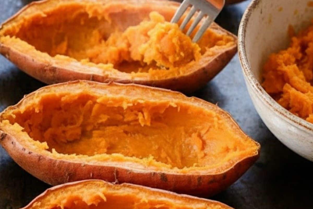 Slice the cooked sweet potatoes open lengthwise and gently scoop out most of the flesh, leaving about an inch around the edges so the skins can hold their shape, then set the scooped flesh aside for the filling. - 4
