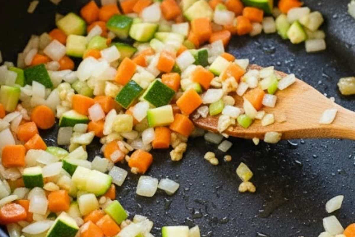 In a pan over medium heat, sauté onion, garlic, carrot, and zucchini until the onion becomes soft - 5