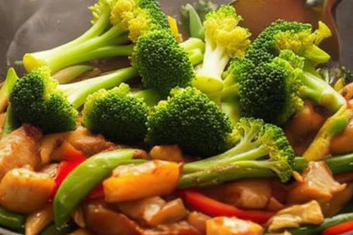add broccoli, snow peas, green beans, red capsicum and baby corn into the wok