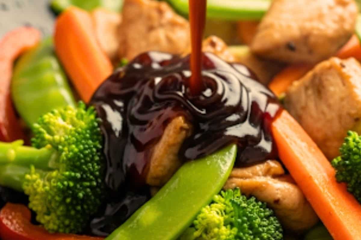 Add the chicken into the wok and add garlic, oyster sauce, soy sauce and brown sugar