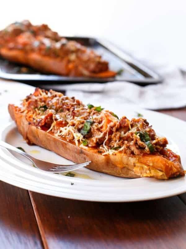 Cheesy Bacon Bolognese Stuffed Sweet Potatoes on a plate