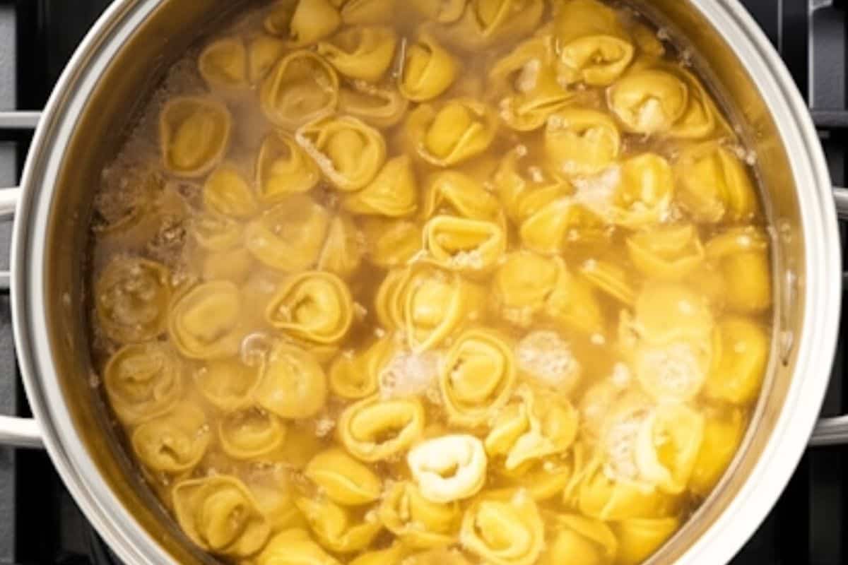 Cook the tortellini in a large pot it boiling water.
