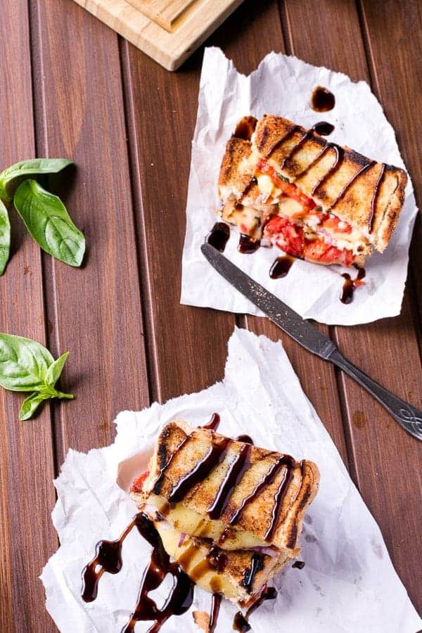 2 pieces Caprese Grilled Cheese sandwich kept on wooden table  