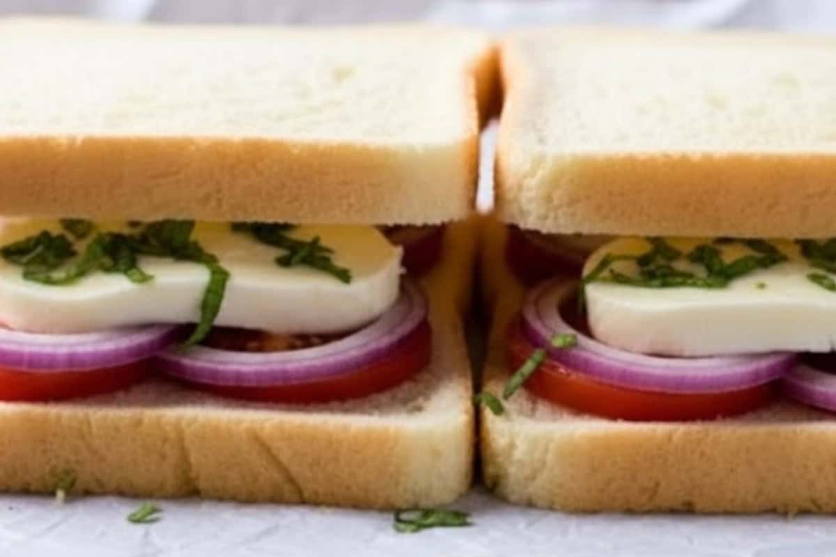 Place the remaining bread slices on top and brush the outsides lightly with garlic olive oil.