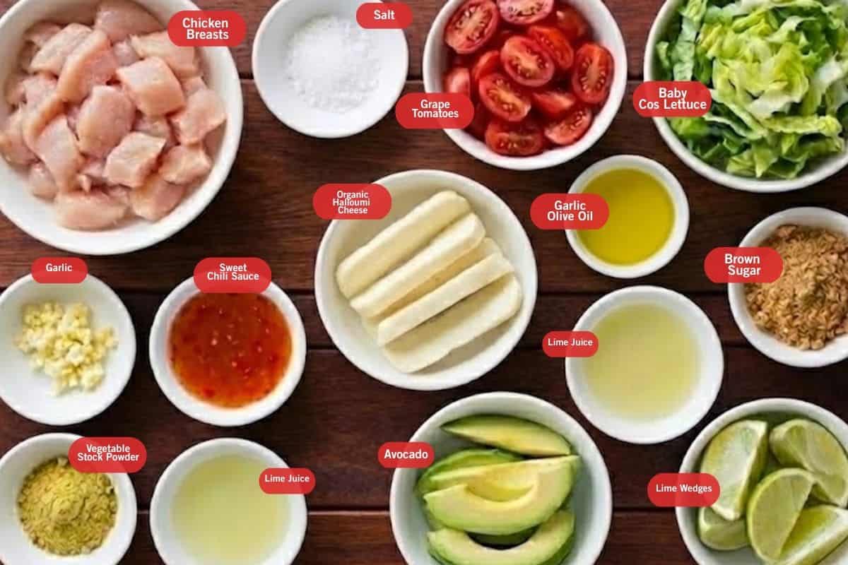 Flat lay photo of ingredient shot of chicken breasts, salt, grape tomatoes, baby cos lettuce, brown sugar, lime wedges, lime juice, garlic olive oil, avocado, sweet chili sauce, garlic, vegetable stock powder - 2