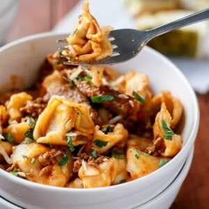 Fork holding a piece from Tortellini with Chunky Beef Sauce