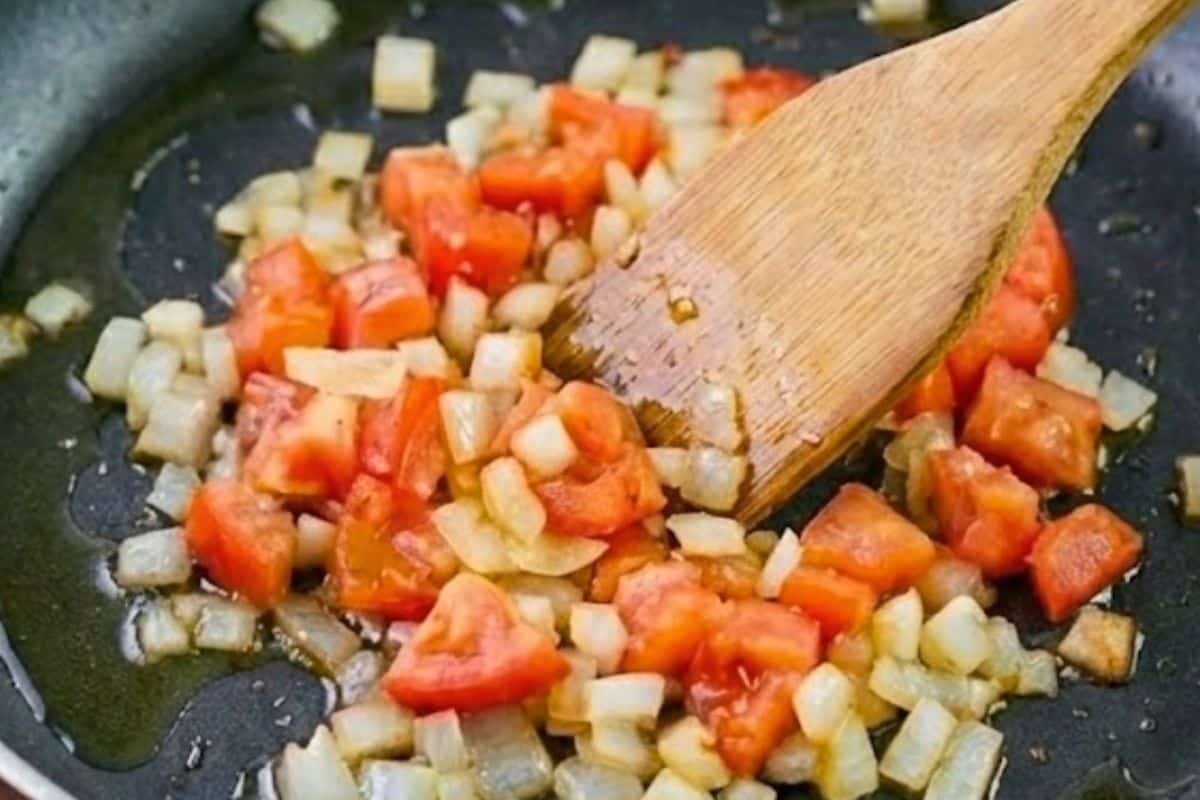 Heat a nonstick pan with oil and add onion and add the tomatoes and sauté - 3
