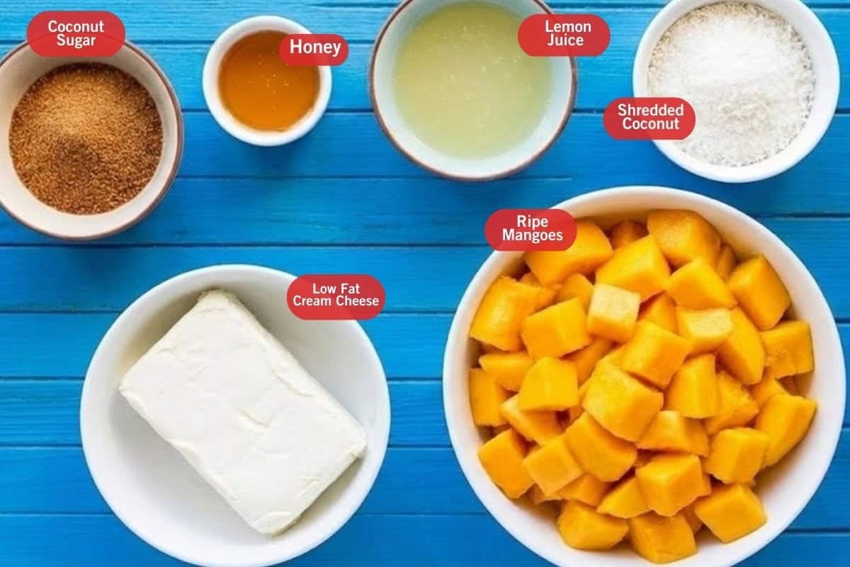 Flat lay photo of ingredient shot of coconut sugar, honey, lemon juice, shredded coconut, low fat cream cheese, ripe mangoes. - 2