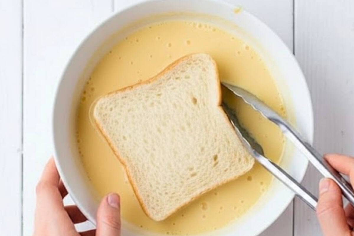 Place each sandwich in the egg mixture and let it absorb liquid