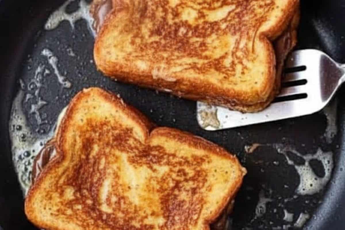 Fry each sandwich on both sides until the bread is golden.