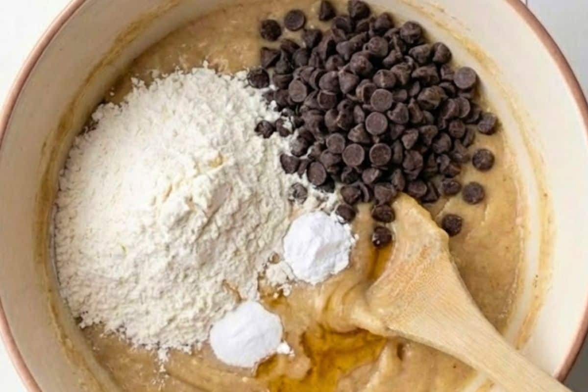 Fold in the flour, chocolate chips, baking powder, bicarbonate of soda, and honey  - 6