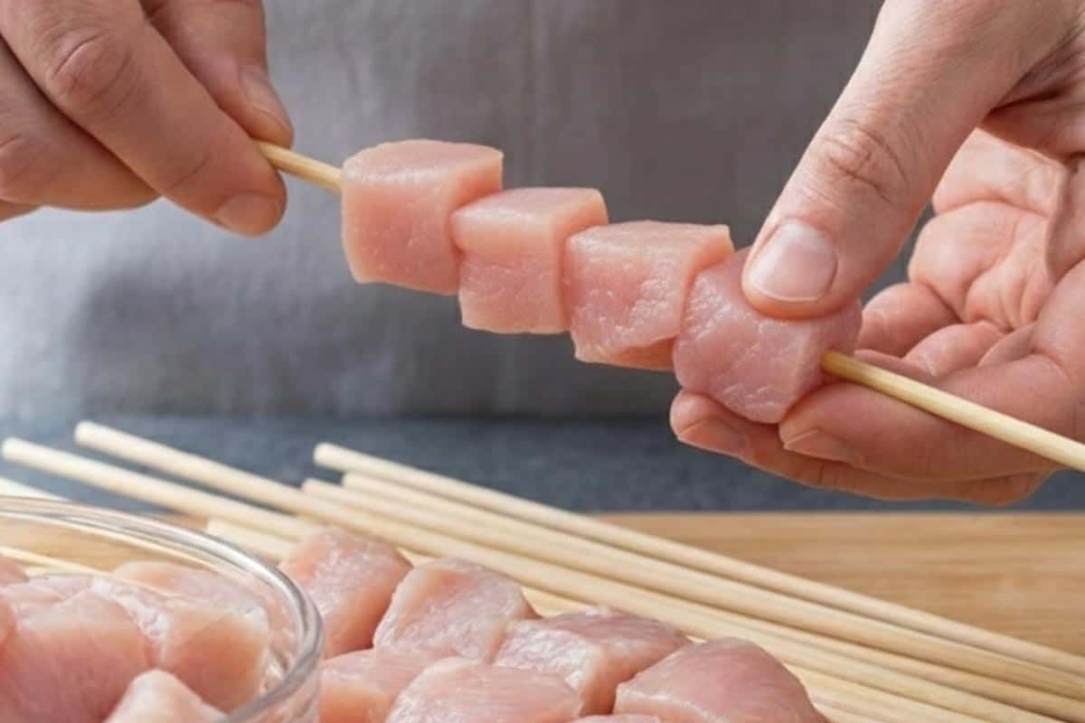 Threading the cubed turkey onto the soaked skewers. - 4
