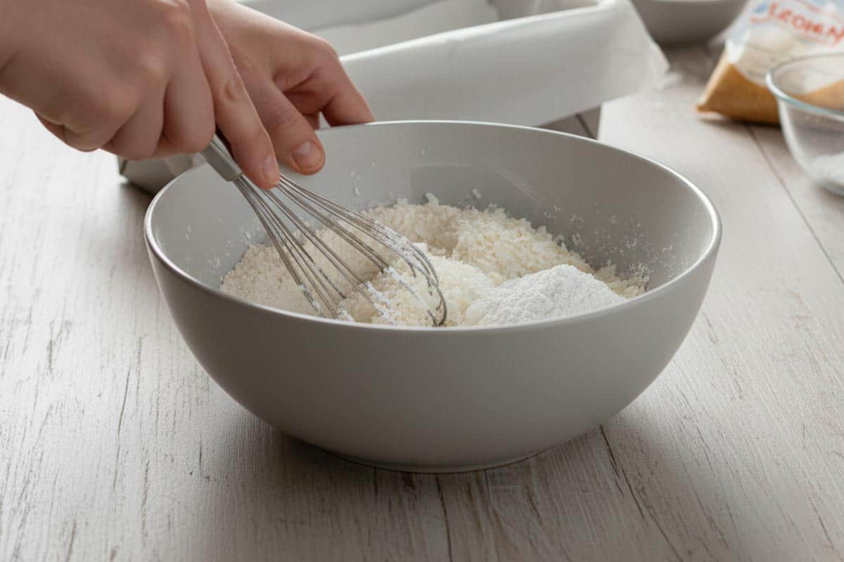 Mixed the flour, coconut, sugar or sweetener, and baking powder in a large bowl.