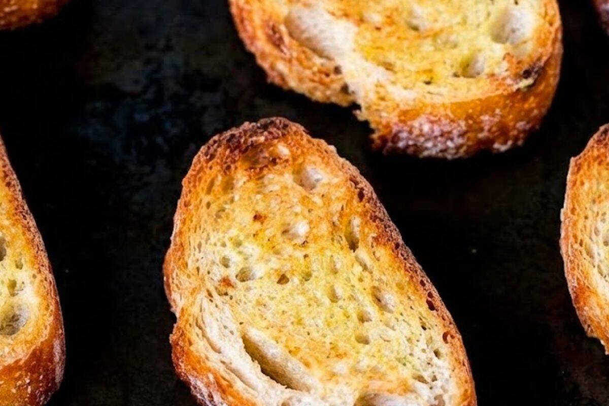 Preheat your grill or broiler to medium high, arrange the bread slices on a lightly greased tray, and toast until golden and crisp. - 3
