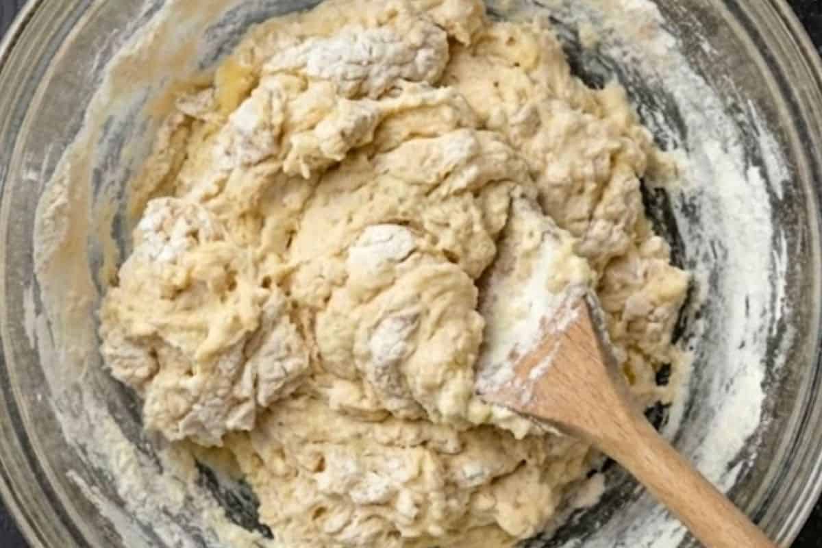 Pour melted butter and buttermilk into the center of the mix and gently fold until a soft dough forms. - 6