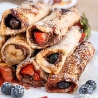 Nutella Fruit French Toast Cannoli rolls stack on each other on a plate