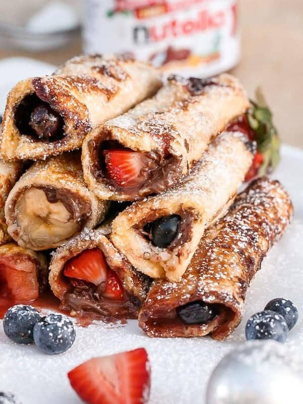 Nutella Fruit French Toast Cannoli rolls stack on each other on a plate