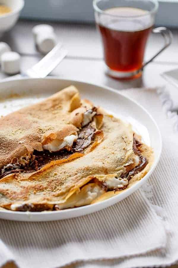 Beautiful golden Crepes full of Graham cracker crumbs Nutella S’mores Crepes