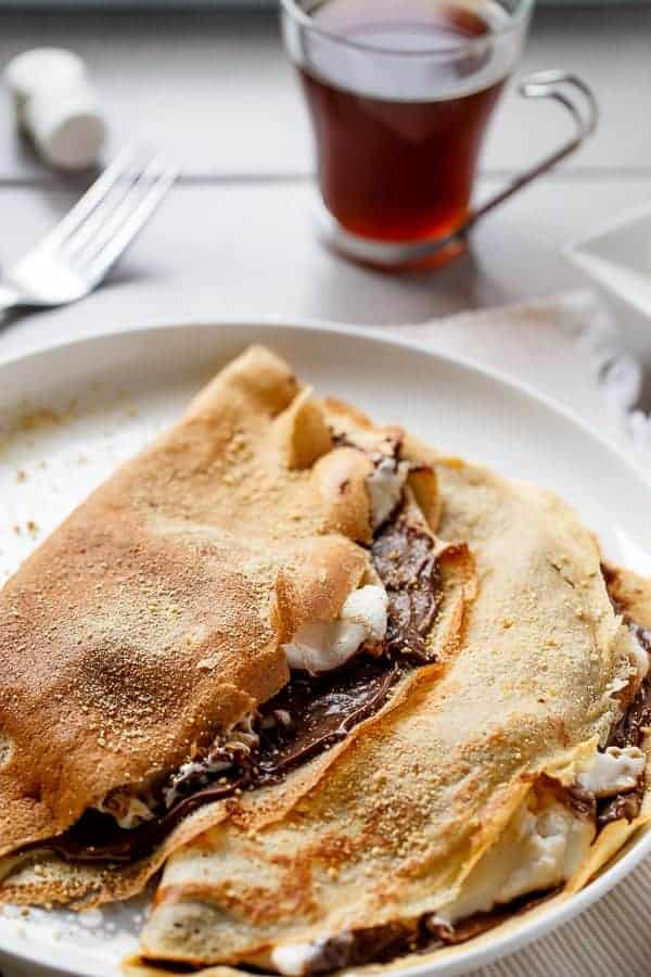 Beautiful golden Crepes full of Graham cracker crumbs Nutella S’mores Crepes