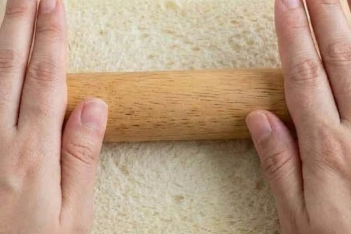 Trim the crusts from each slice of bread, then gently flatten with a rolling pin  - 4