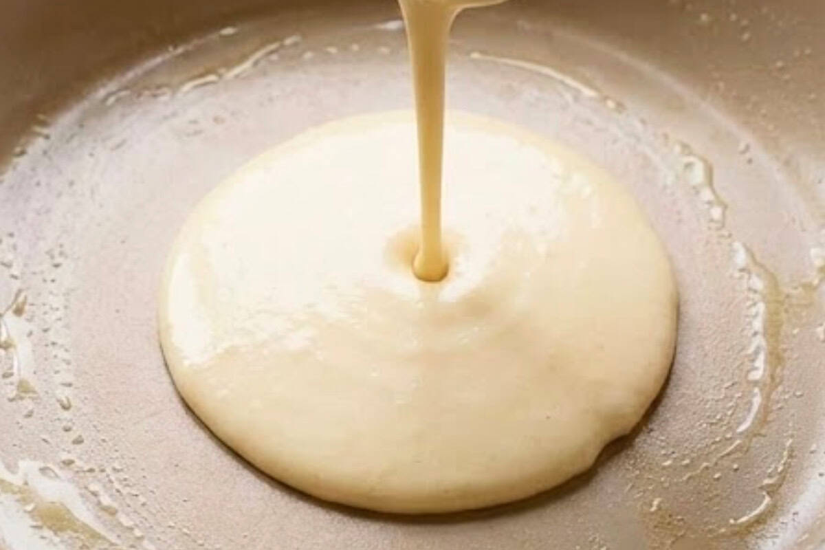 Add 1/4 cup batter to the center and swirl the pan to spread it into a thin crepe.