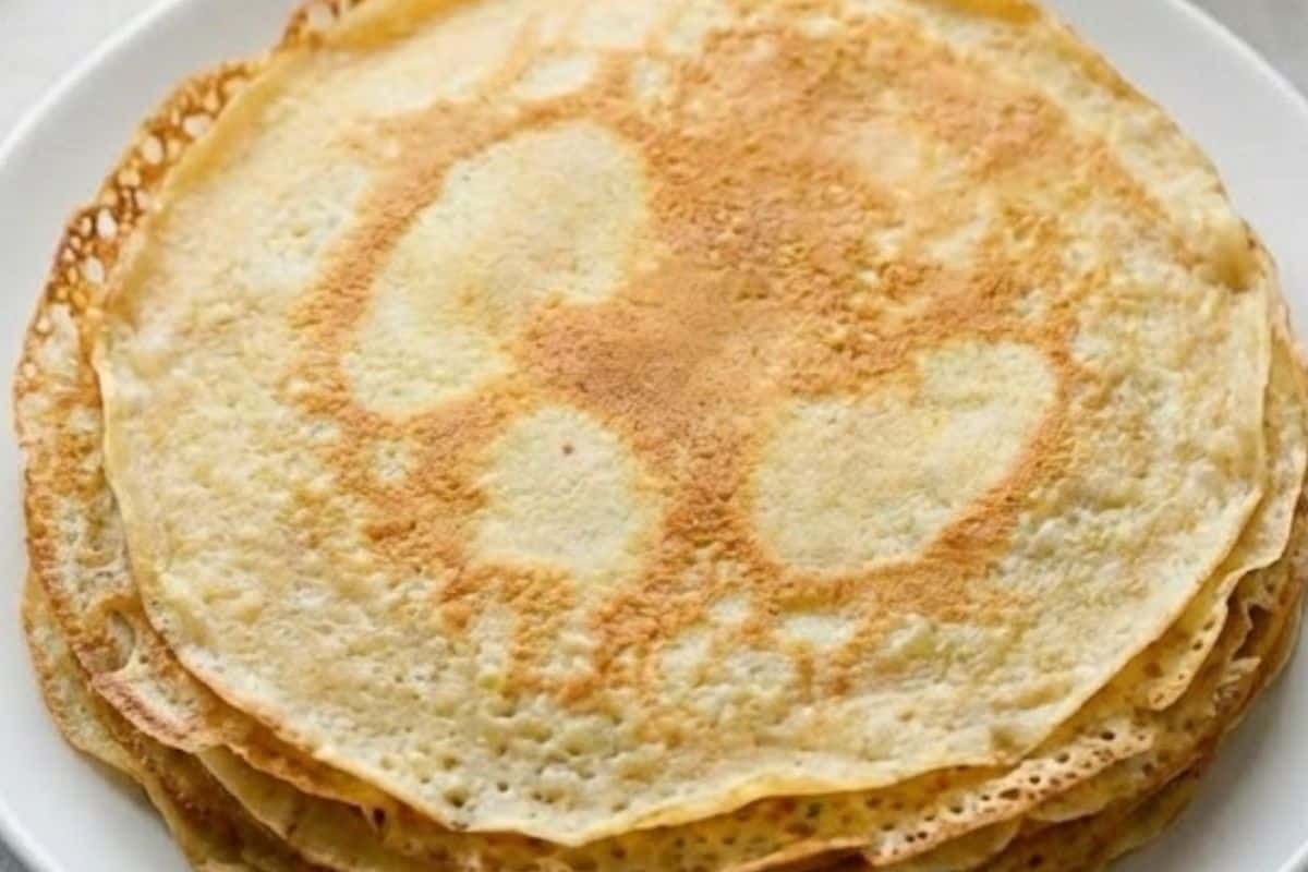 Continue cooking crepes with remaining batter and stack to keep warm.