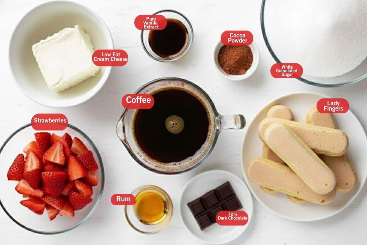 Flat lay photo of ingredient shot of low fat cream cheese, pure vanilla extract, cocoa powder, white granulated sugar, lady  fingers, 70% dark chocolate, rum, strawberries, coffee - 2