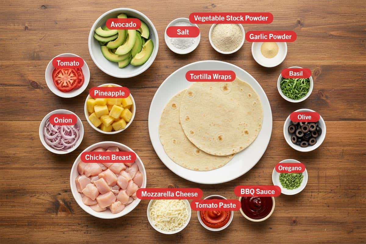 Top shot of ingredients: avocado, salt, vegetable stock powder, garlic powder, basil, olive, oregano, BBQ sauce, tomato paste, mozzarella cheese, chicken breast, pineapple, and onion.