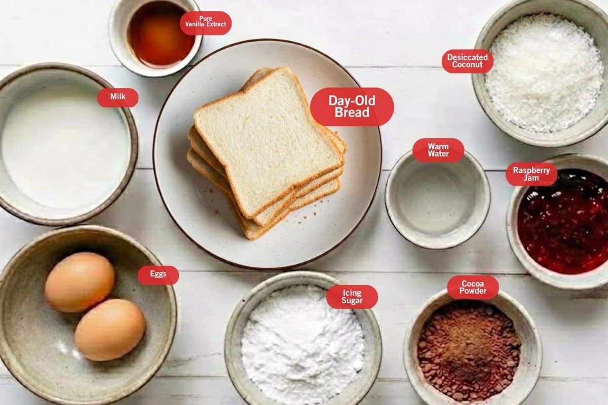 Flat lay photo of ingredient shot of pure vanilla extract, day old bread, milk, desiccated coconut, raspberry jam, cocoa powder, icing sugar, eggs warm water - 2