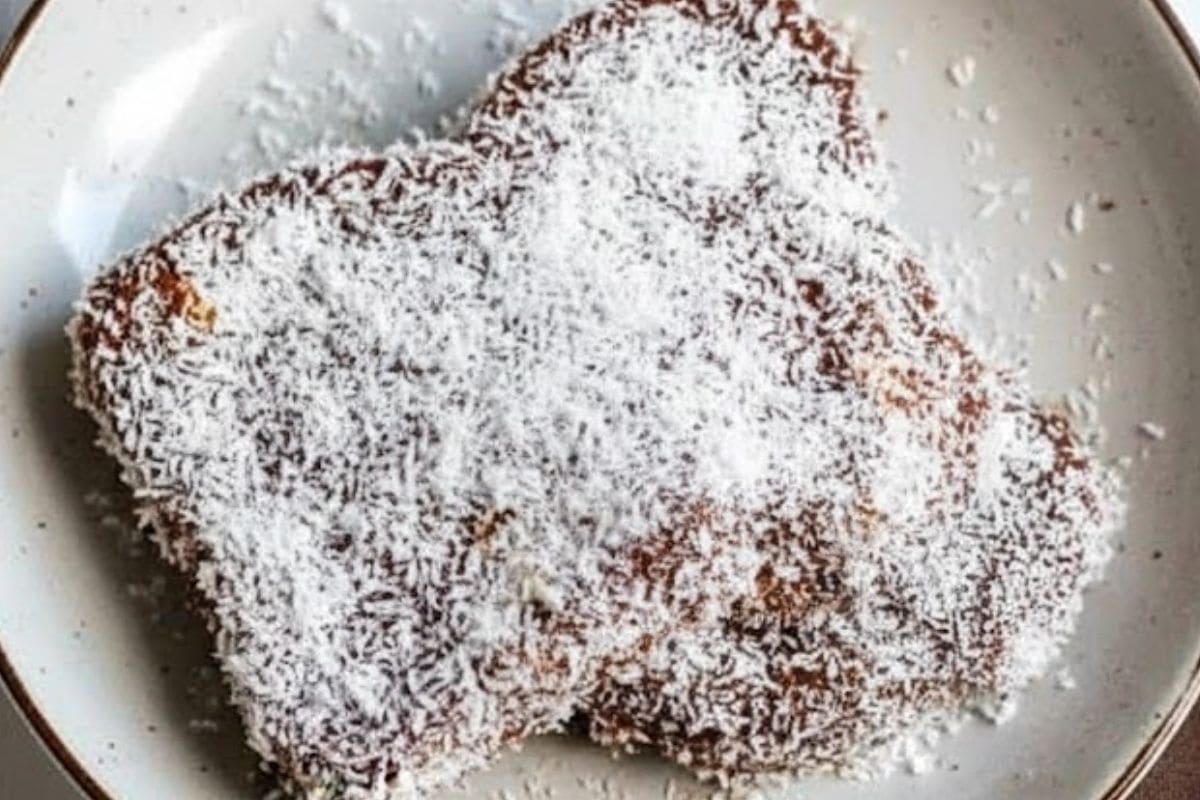 Dip each slice of Lamington Bread into the chocolate icing, let any excess drip away, then roll through the coconut until evenly coated. - 6