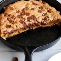 The best buttery and gooey Nutella stuffed deep dish chocolate chip skillet cookie will have you weak at the knees wanting more! There's nothing better than a warm chocolate chip cookie straight out of the oven, especially one that is oozing with chocolate hazelnut Nutella. Every bite melts in your mouth! | cafedelites.com