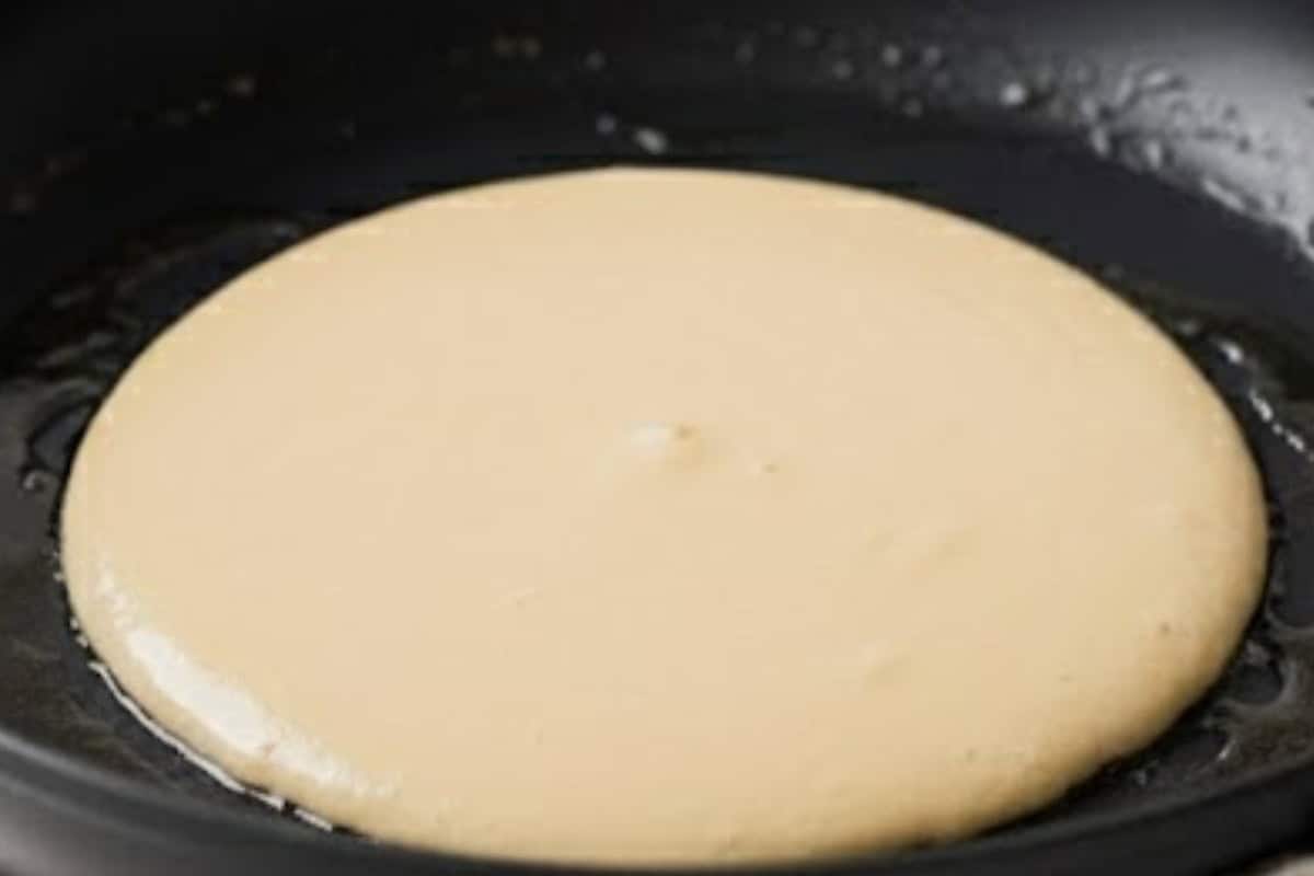 Pour slightly less than one fourth cup of batter into the pan