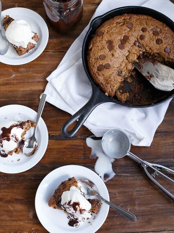 3 bowls filled with Peanut Butter Choc Chip Deep Dish Skillet Cookie with ice cream scoop