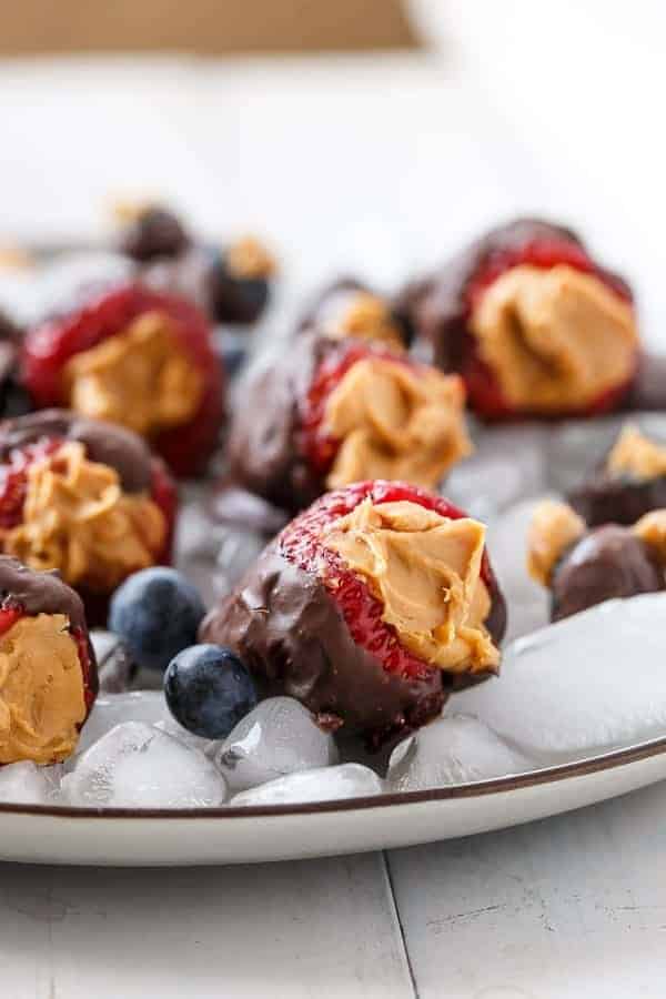 Peanut Butter Stuffed Chocolate Covered Berries on ice cubes