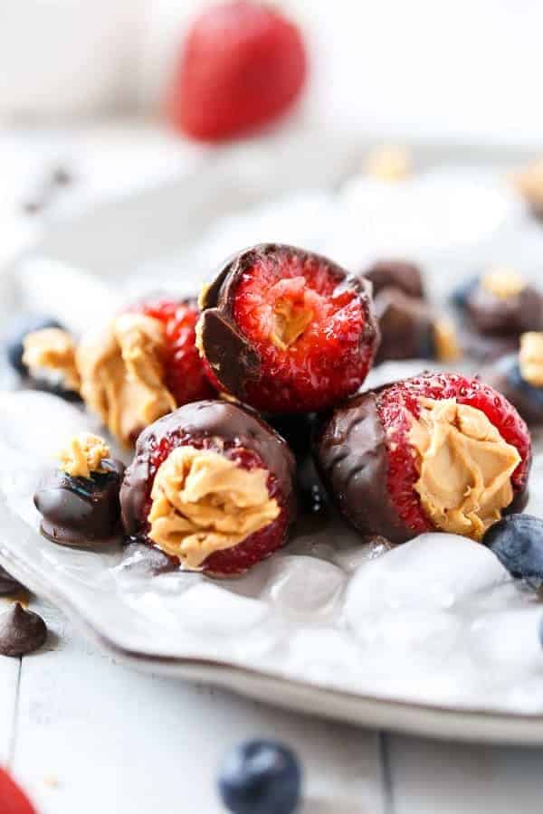 Peanut Butter Stuffed Chocolate Covered Berries on ice cubes