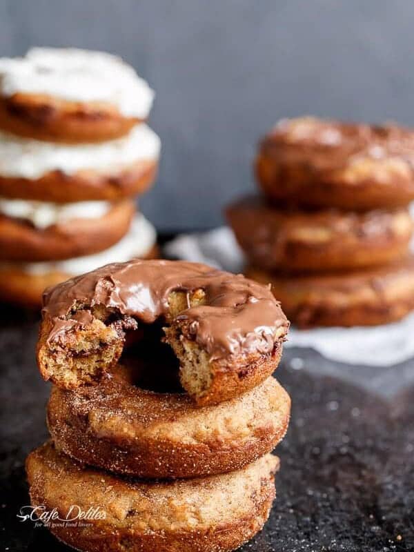 Nutella Stuffed Baked Banana Bread Donuts with Cream Cheese Frosting being stack on each other
