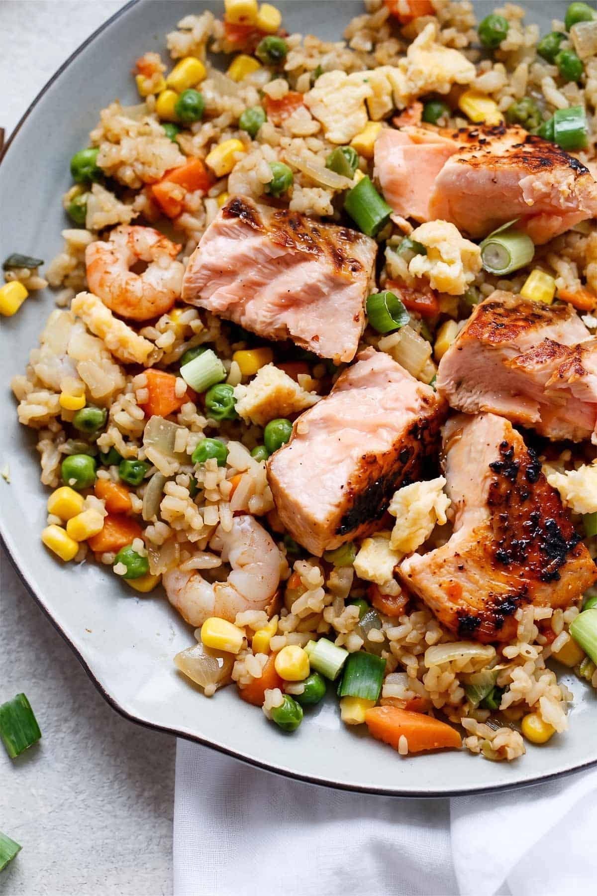 Close Up of Seared Salmon and Prawn Fried Rice with on a plate