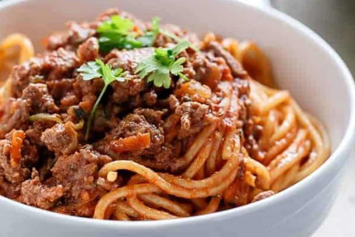Spaghetti Bolognese in a white bowl.