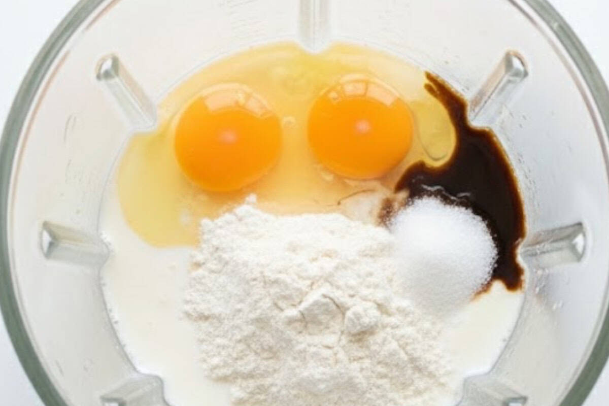 Add eggs, oil, pure vanilla extract, sugar, milk and all purpose flour in a blender and blend mixture until smooth.