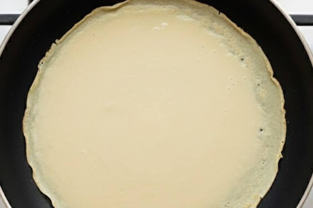 Pour one fourth cup of batter into the pan, swirl to coat the base in a thin layer