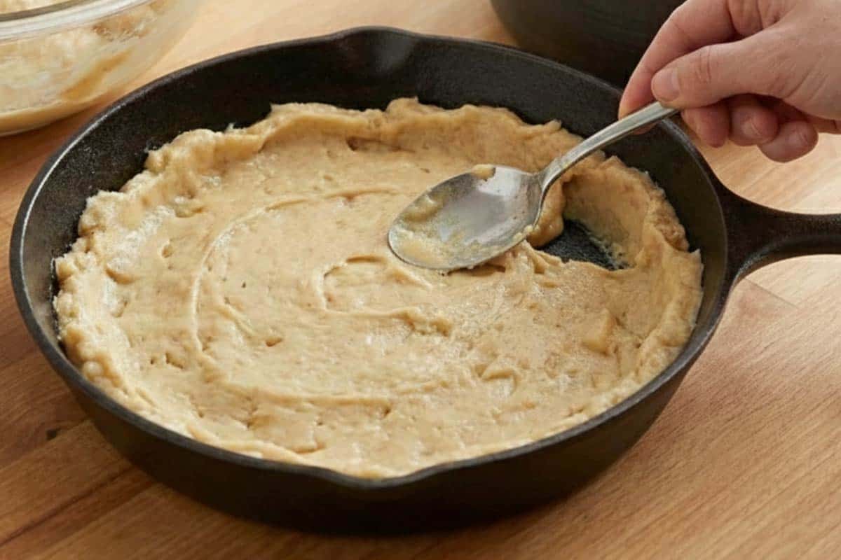 Spreading the cookie dough in the pan. - 7