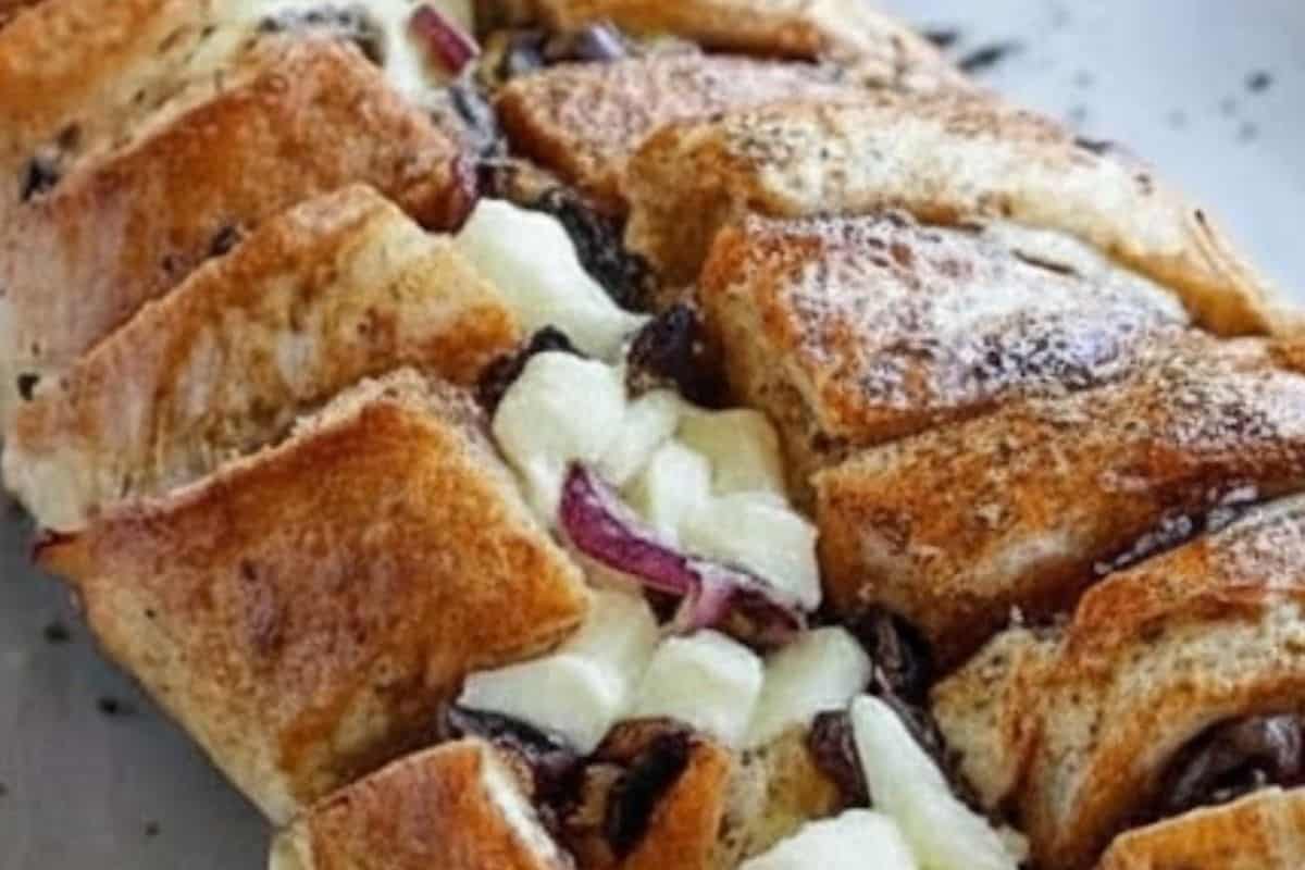 Tuck the chicken, mozzarella, onions, olives, and mushrooms into all the cuts - 6