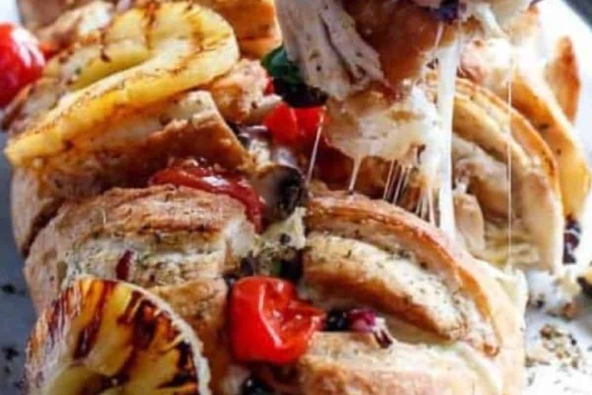 Top with the grilled pineapple and tomatoes, and finish with fresh shredded basil before serving. - 10