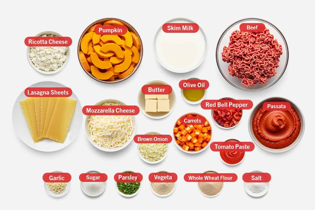 Top shot of ingredients: ricotta cheese, pumpkin, skim milk, beef, lasagna sheets, mozzarella cheese, butter, olive oil, red bell pepper, passata, brown onion, carrots, tomato paste, garlic, sugar, parsley, vegeta, whole wheat flour, and salt.