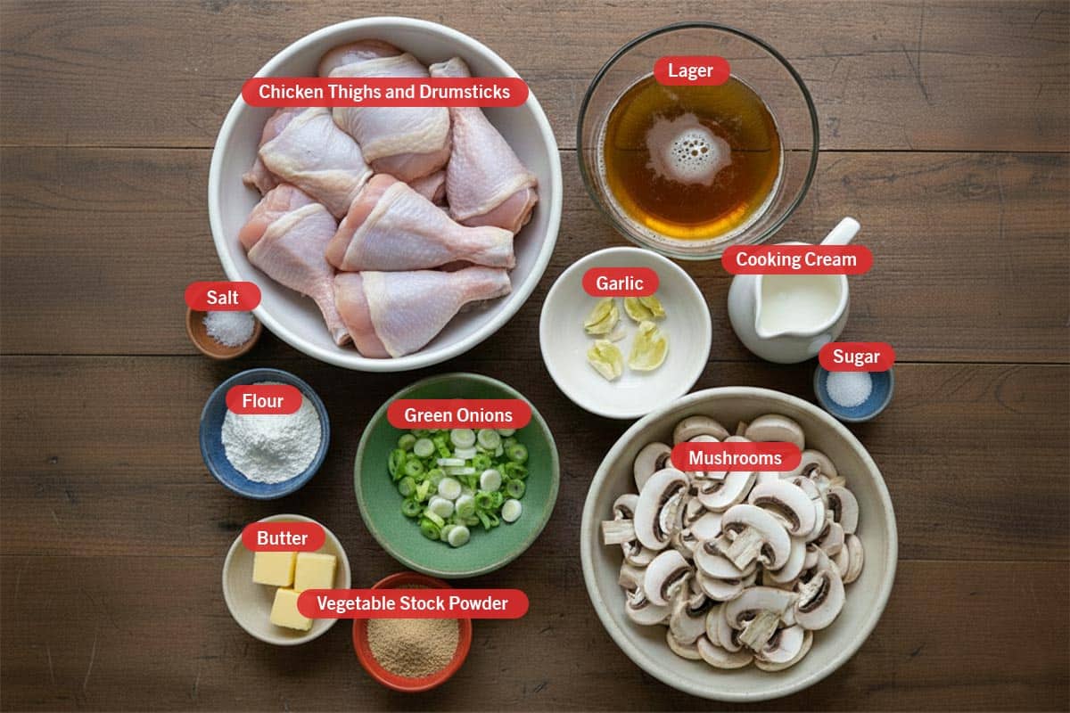 Top shot of ingredients: chicken thighs and drumsticks, lager, salt, flour, green onions, garlic, cooking cream, sugar, butter, vegetable stock powder, and mushrooms. - 2